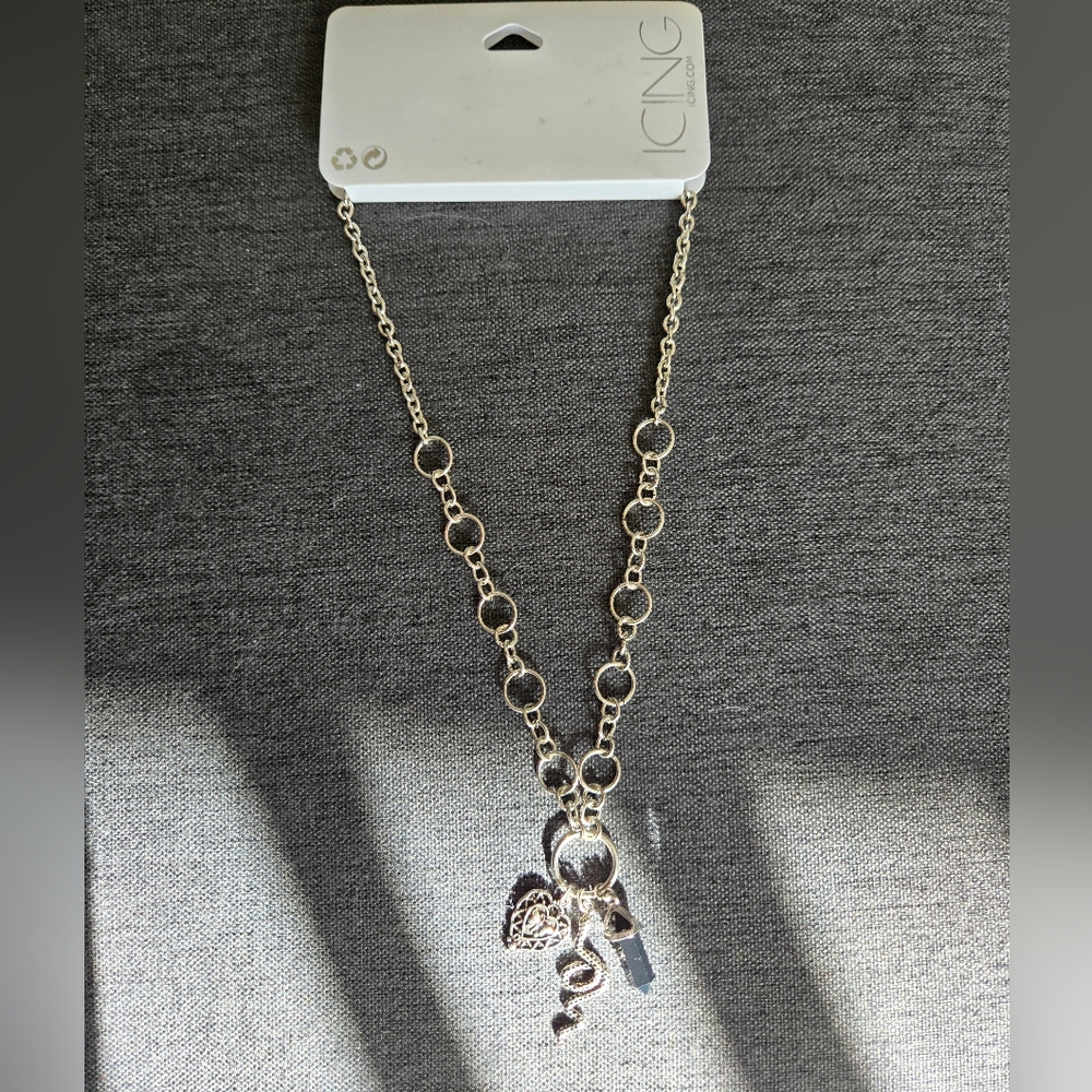 Icing Silvertone Nklc w/3Charms, Heart, Snake, and Black Stone Like 16"w/3" ext.